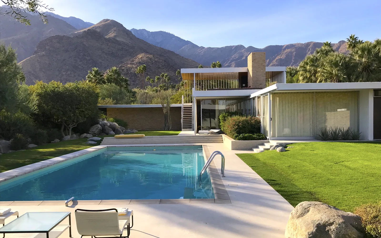 Modern mid-century desert home with pool deck and architectural details