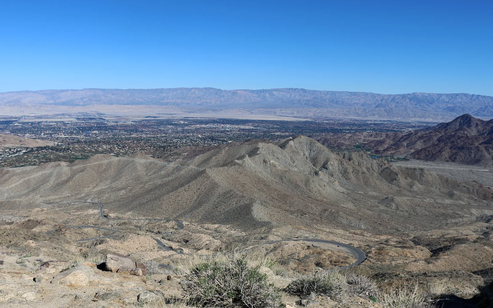 Desert landscape of the Coachella Valley with mountains in the distance under clear skies